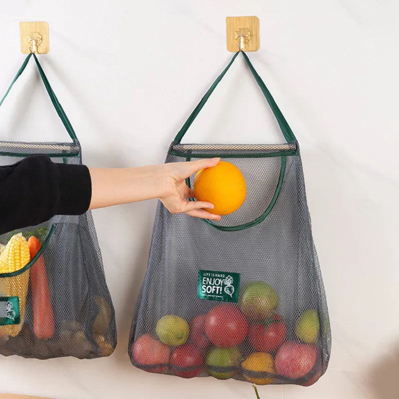 Reusable mesh storage bags hanging in a kitchen, ideal for organizing vegetables with the Hot Trend Vault brand.