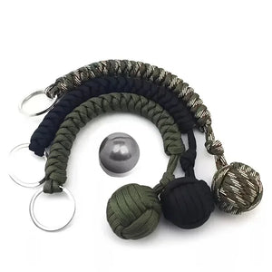 Outdoor self-defense umbrella rope kit with monkey fist steel ball and paracord key chain, ideal for outdoor enthusiasts.