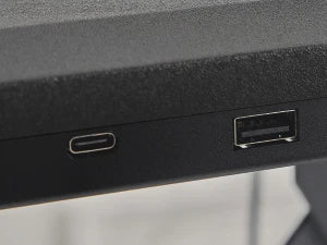 Redlife standing desk converter with wireless charger, adjustable height, and spacious surface for office workspace.