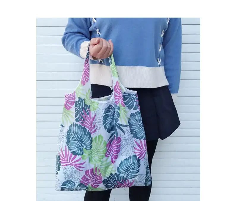 Large eco foldable tote shopping bag for women by Hot Trend Vault, featuring reusable design with accompanying carrying case.