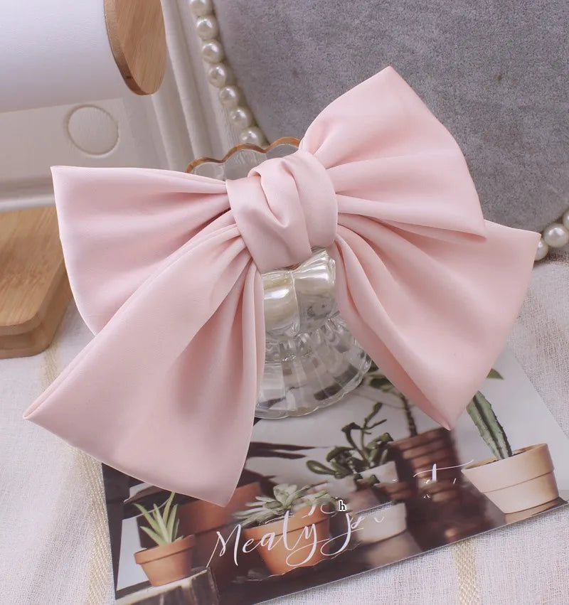 Oversized satin bow knot hair clip by Hot Trend Vault, elegant barrette accessory for women, showcased on a model's hair.