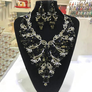 StoneFans rhinestone drop necklace and earrings set for women featuring glamorous exaggerated drag queen style, shiny rhinestones and bold design.