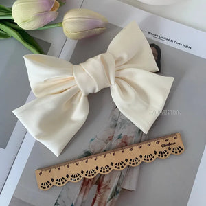 Elegant satin barrette hair clip with oversized bow knot design for women, featuring a stylish accessory from Hot Trend Vault.