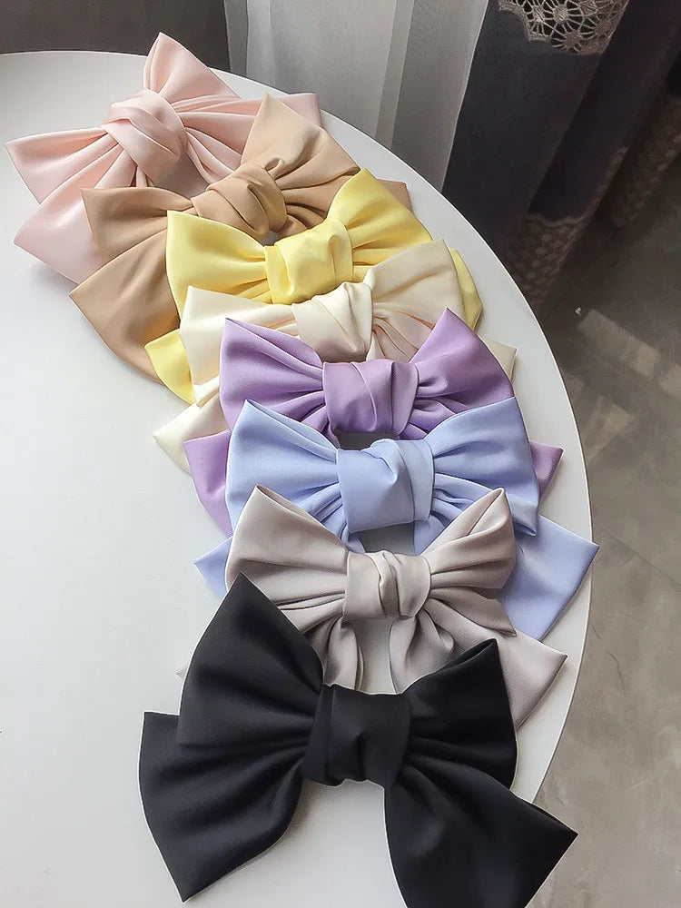 Elegant satin bow barrette by Hot Trend Vault featuring an oversized knot hair clip for women.