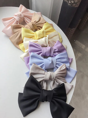 Elegant satin bow barrette by Hot Trend Vault featuring an oversized knot hair clip for women.