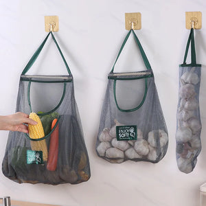 Reusable mesh storage bags hanging in a kitchen, ideal for organizing vegetables and produce by Hot Trend Vault.