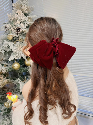 Velvet oversize bow hair clip for women and girls, stylish accessory from Hot Trend Vault, shown in black with a large bow design.