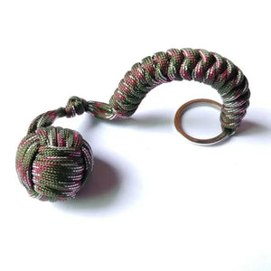 Outdoor self-defense umbrella rope kit with monkey fist steel ball and paracord key chain, designed for outdoor enthusiasts.