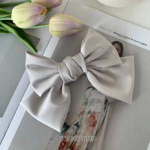 Oversized satin bow knot hair clip by Hot Trend Vault, elegant barrette accessory for women, showcasing a smooth satin finish.