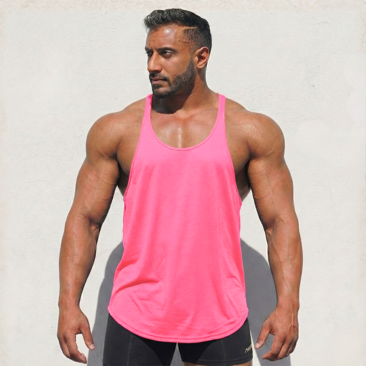 Neon pink original stringer tank top by Physique Bodyware, made in the USA, featuring sleeveless athletic design for workout wear.