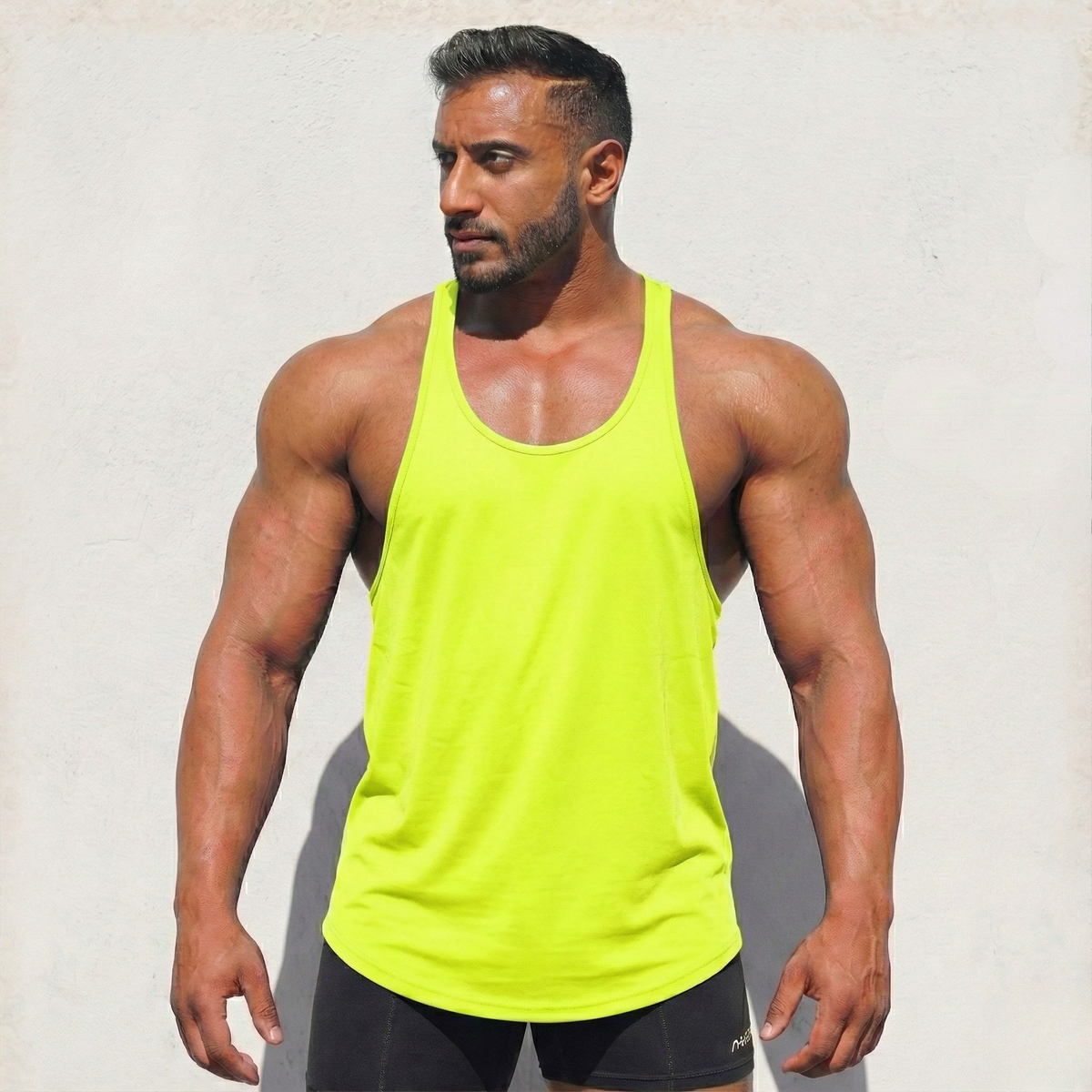 Neon yellow original stringer tank top by Physique Bodyware, made in the USA, displayed on a plain background.