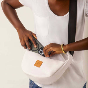 White round mini vegan leather shoulder bag with Kenyan fabric lining, compact and stylish crossbody bag from Ecodunia.