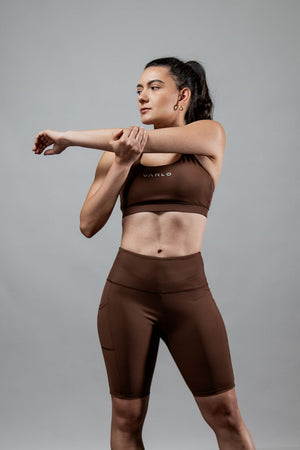 Women wearing Hot Trend Vault City Mocha breathable cross-back sports bra, supportive and comfortable for active wear.