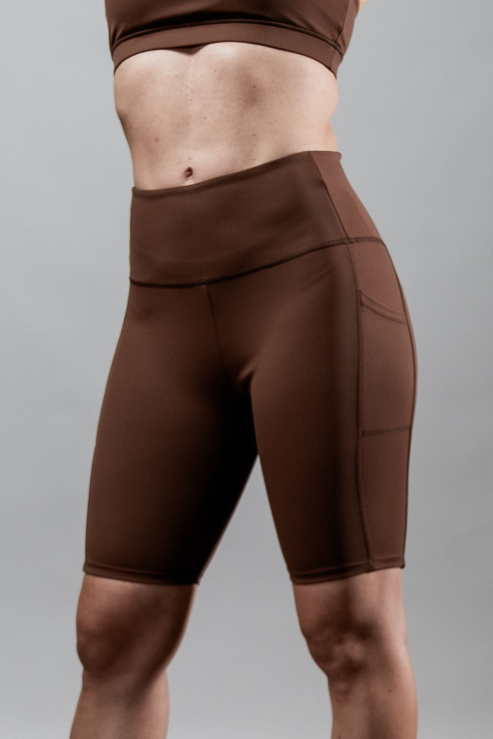 Women wearing Hot Trend Vault SOHO Fitness Shorts in City Mocha, 8-inch length, activewear for workout and active lifestyle.