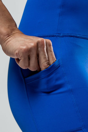Women wearing Hot Trend Vault SOHO fitness shorts in Neo Blue, 8-inch length, designed for all-day comfort.