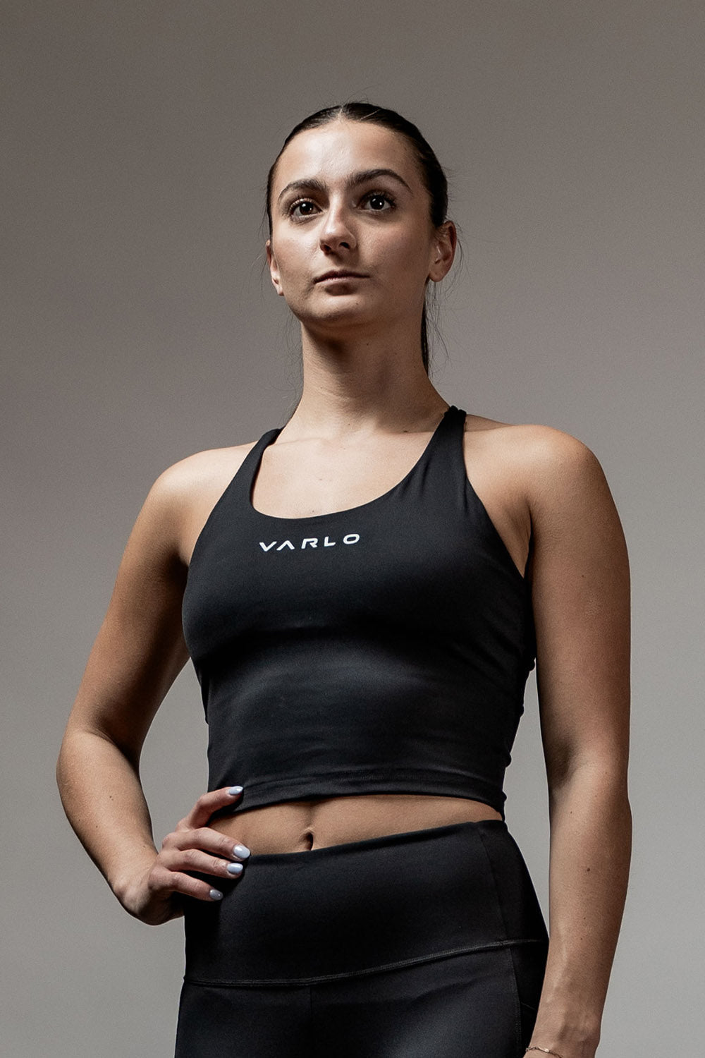 Black SOHO women's cross-back crop tank top by Hot Trend Vault featuring sleek support and a stylish, fitted design.