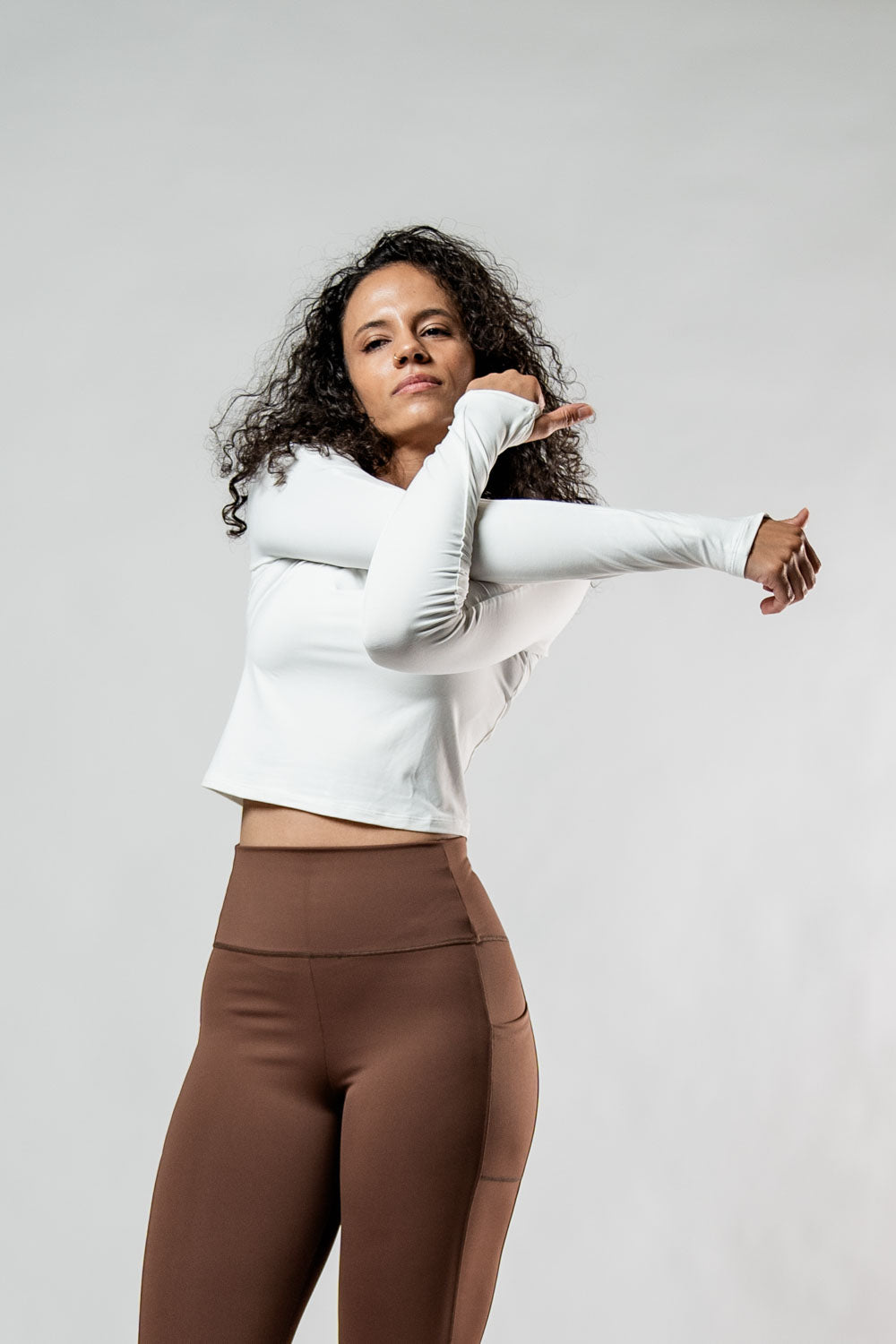 Women's white Terra Recovery Arc long sleeve crop T-shirt by Hot Trend Vault, soft fabric, fitted style, shown on a model.