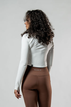 Women's white long sleeve crop t-shirt from Hot Trend Vault with soft fabric and recovery arc design.