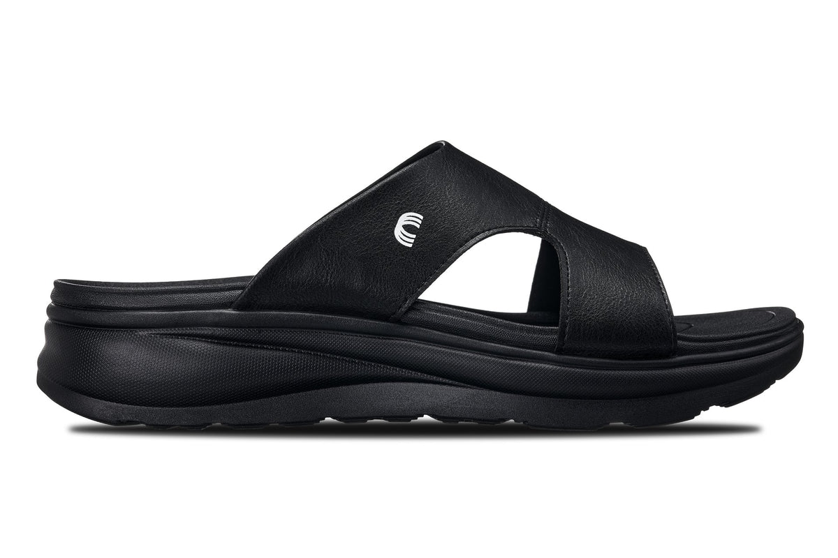 Black Calto X1655 height-increasing sandals by Hot Trend Vault with grainy finish and 2-inch lift for added height.