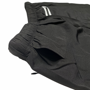 Black men's Pro Short with 5-inch inseam, compression fit, and zippered pockets from Hot Trend Vault activewear.