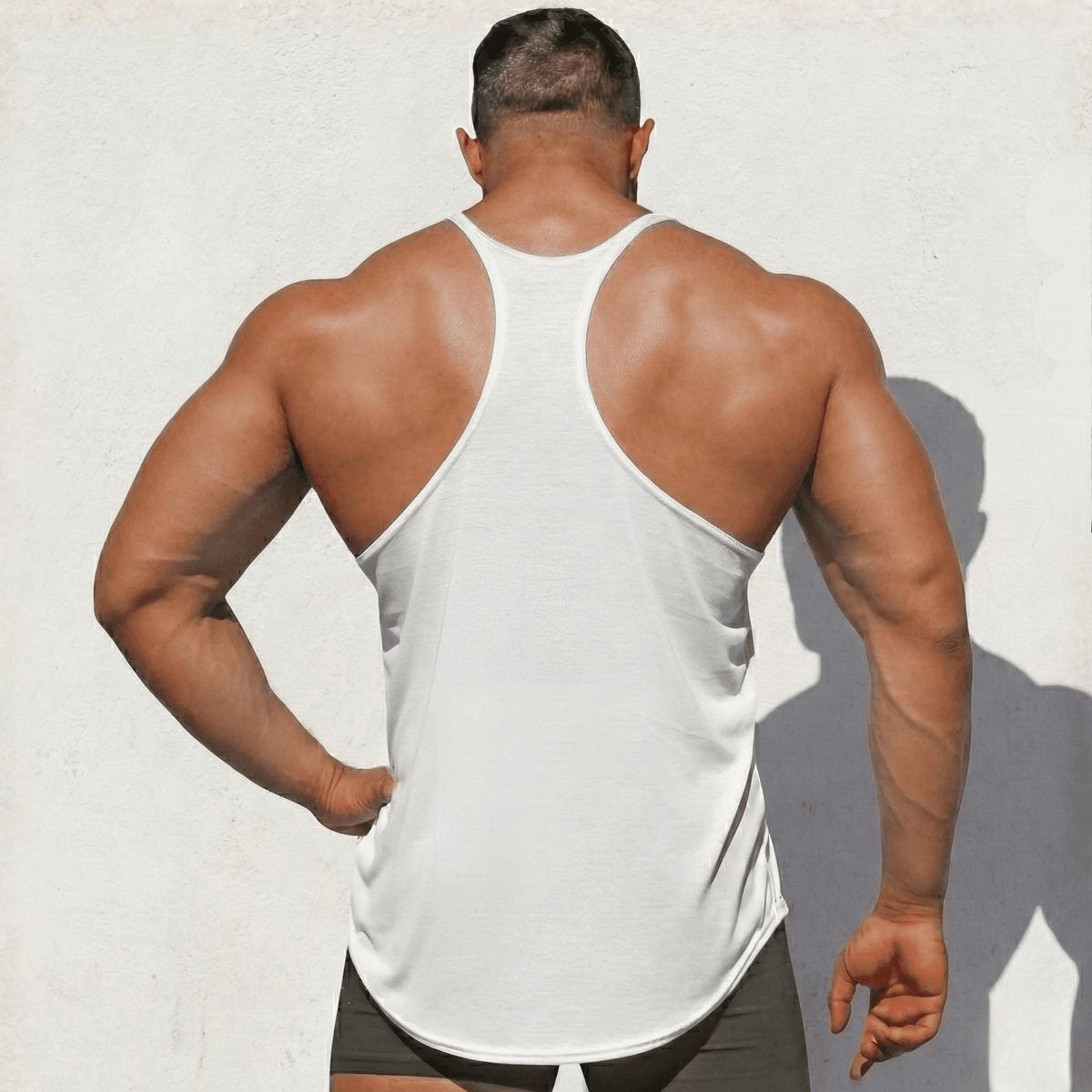 Black Original Stringer Tank Top by Physique Bodyware, made in the USA, featuring a sleeveless design for athletic wear.
