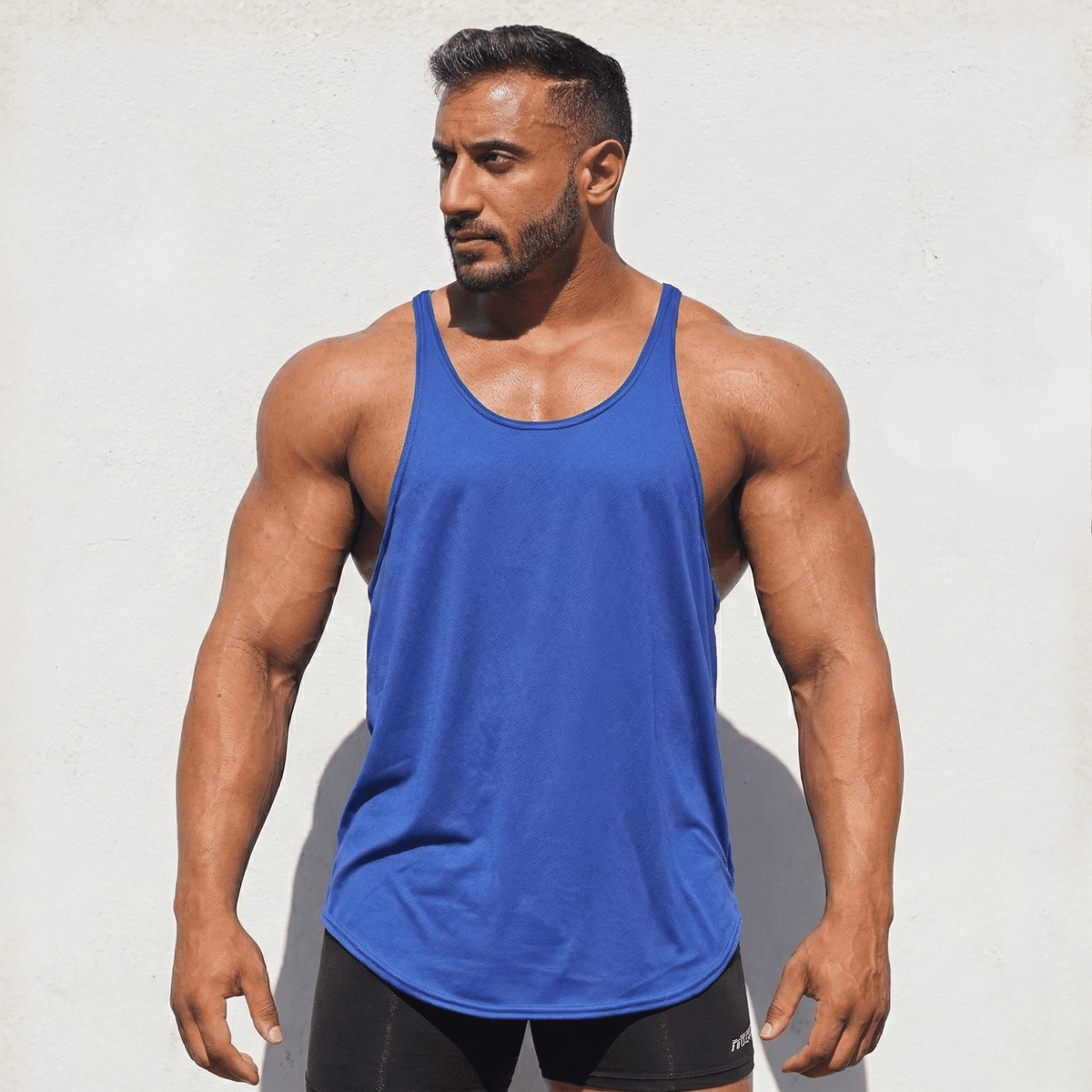 Black Original Stringer Tank Top by Physique Bodyware, made in the USA, featuring a sleeveless design ideal for gym workouts.