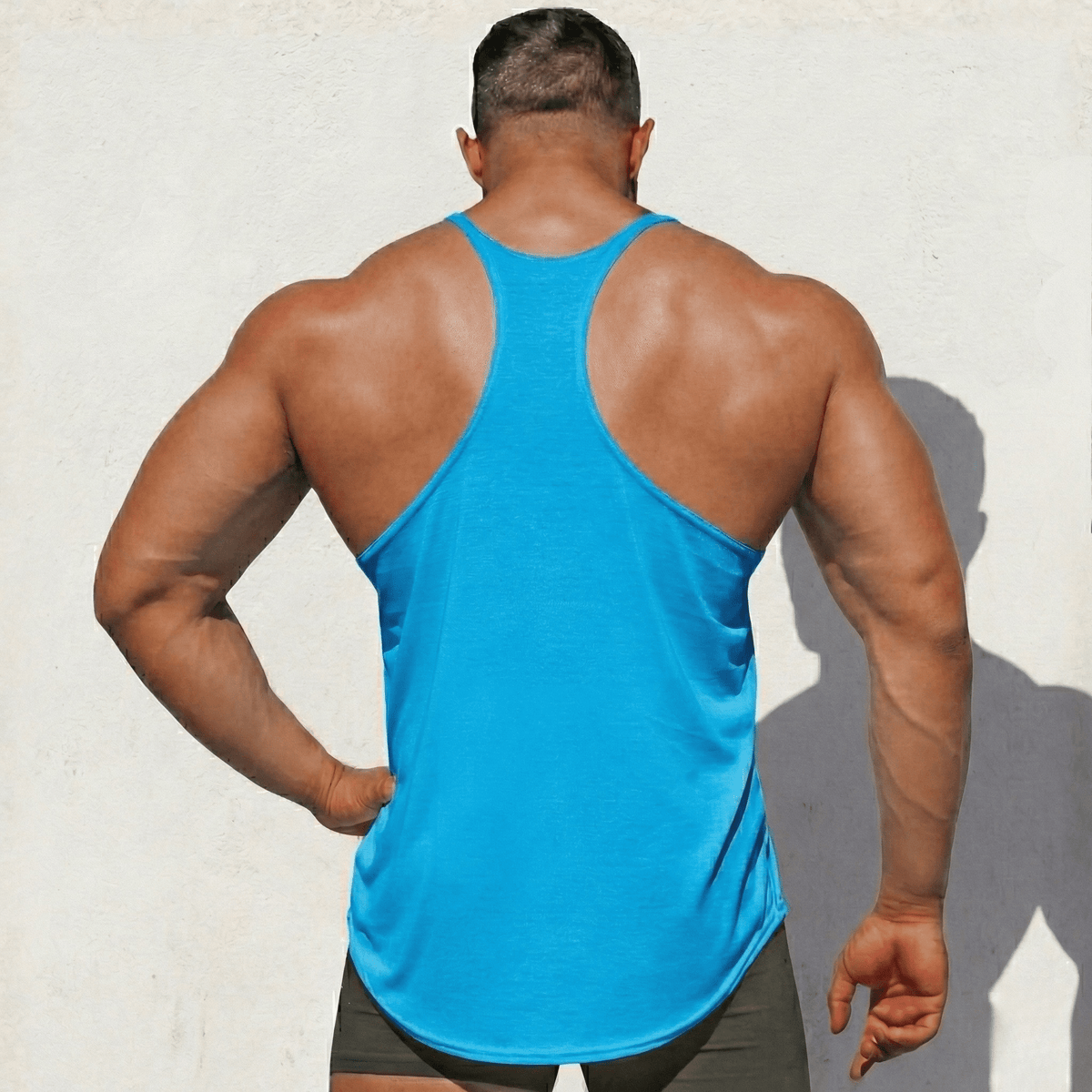 Hot Trend Vault original stringer tank top made in the USA, showcasing a fitted sleeveless athletic shirt with a logo detail.