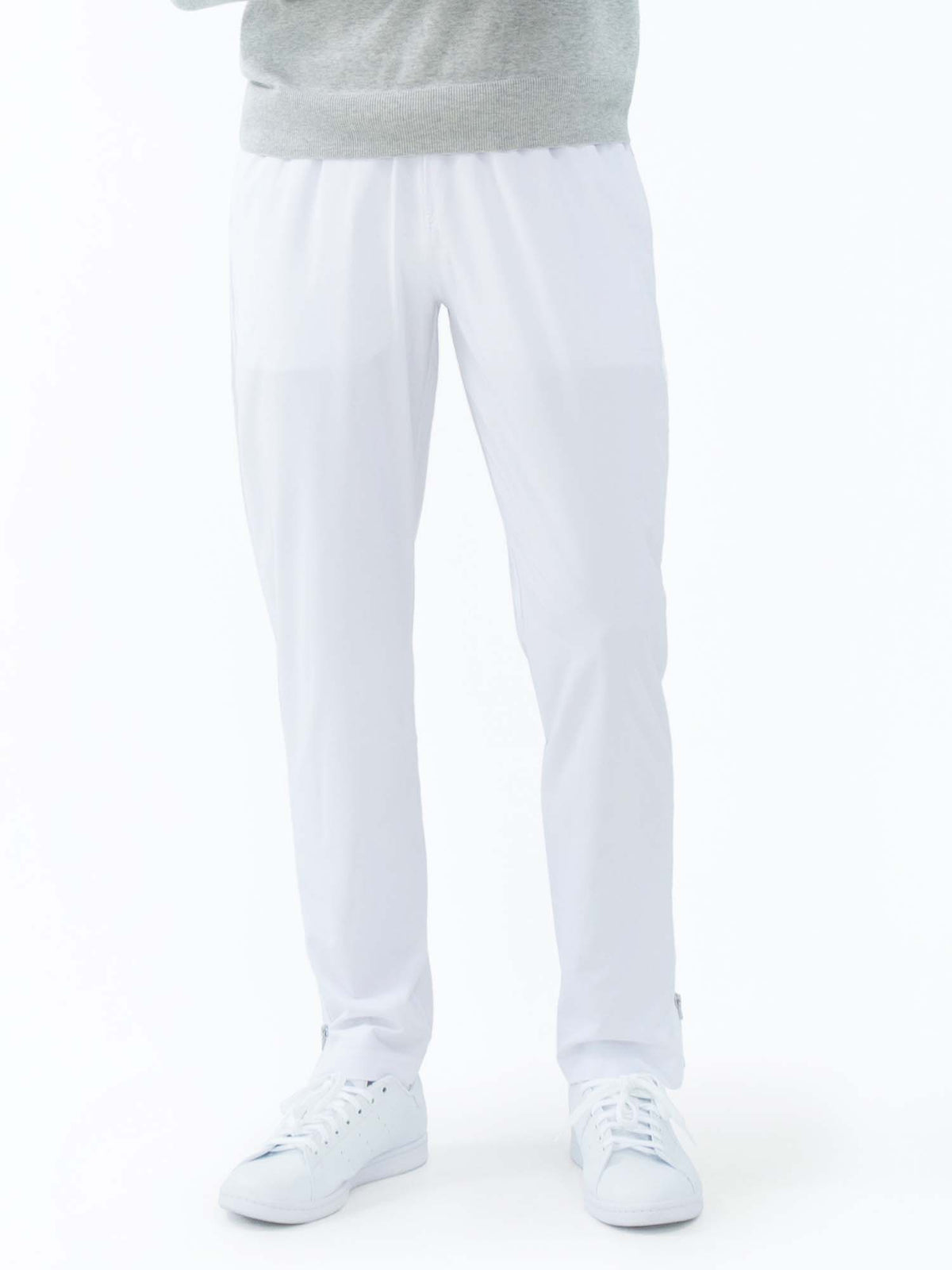 Men's white tennis pants by Hot Trend Vault featuring quick-dry fabric and zippered leg openings for performance and comfort.
